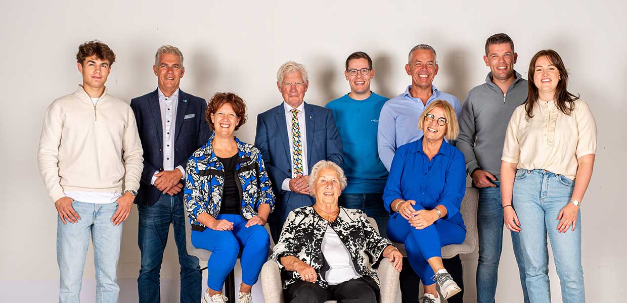 Groepsfoto van de Kapenga familie, gekleed in casual en zakelijke kleding, zittend en staand geposeerd