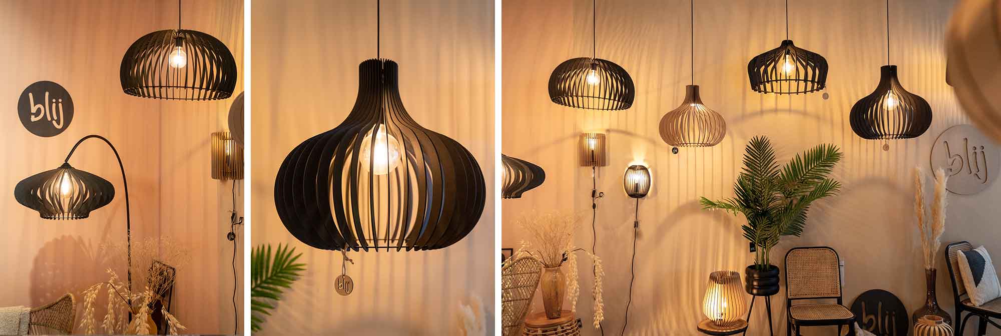 Zwarte designlampen van Blij Design, met houten lamellen en warme verlichting, creëren een stijlvolle, natuurlijke sfeer.